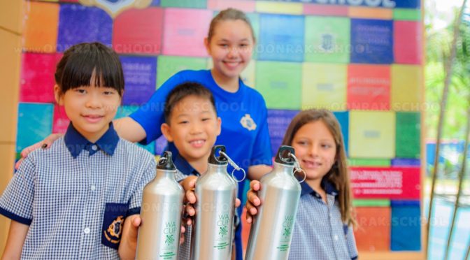 smiling children at Thailand school holding aluminium water bottles